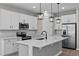 Modern kitchen featuring white cabinets, stainless steel appliances, and a large center island at 1717 Hilltop Dr, Dundee, FL 33838