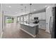 Bright kitchen with island, pendant lighting, stainless appliances, and seamless living space at 1717 Hilltop Dr, Dundee, FL 33838
