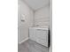 Functional laundry area equipped with modern washer and dryer set and extra storage shelf at 1717 Hilltop Dr, Dundee, FL 33838