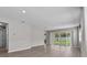 Bright living room with sliding glass doors leading to outdoor space at 1717 Hilltop Dr, Dundee, FL 33838