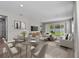Open-concept living area with dining space and sliding glass doors to the backyard at 1717 Hilltop Dr, Dundee, FL 33838