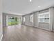 Sunlit living room featuring large windows and sliding glass doors at 1717 Hilltop Dr, Dundee, FL 33838