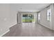 Spacious living room with sliding glass doors, and hardwood floors at 1717 Hilltop Dr, Dundee, FL 33838