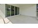 Spacious concrete patio features sliding glass doors accessing interior of the home at 1717 Hilltop Dr, Dundee, FL 33838
