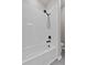 The bath tub has white subway tile and modern, black fixtures at 1717 Hilltop Dr, Dundee, FL 33838