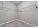 Empty walk-in closet features wire shelving and neutral carpet flooring at 1717 Hilltop Dr, Dundee, FL 33838