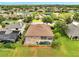 Aerial view showcases the home's position amidst mature trees, water, and community landscape at 1902 Tumblewater Blvd, Ocoee, FL 34761