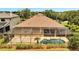 Bird's eye view of fenced-in pool and patio, surrounded by garden, lawn, and mature landscaping at 1902 Tumblewater Blvd, Ocoee, FL 34761
