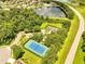 Aerial view showcasing the community amenities, including a tennis court, basketball court, and playground at 1902 Tumblewater Blvd, Ocoee, FL 34761