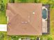 Aerial view of home featuring brown roof, screened-in pool, surrounding green grass, and lush landscaping at 1902 Tumblewater Blvd, Ocoee, FL 34761