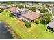 Aerial view of a backyard with a screened pool and fenced yard bordering a pond at 1902 Tumblewater Blvd, Ocoee, FL 34761