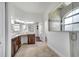 Bathroom featuring dual vanities, tile floors, shower with glass door, and natural light at 1902 Tumblewater Blvd, Ocoee, FL 34761
