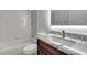 Bathroom features white tile, granite counters, and tub with shower at 1902 Tumblewater Blvd, Ocoee, FL 34761