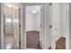 Hallway view with bedroom door ajar with hard wood floors and ceiling fan at 1902 Tumblewater Blvd, Ocoee, FL 34761