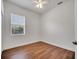 Bedroom with wood-look floors and view of the green outdoors at 1902 Tumblewater Blvd, Ocoee, FL 34761