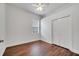 Minimalist bedroom features hardwood floors and a window with privacy blinds at 1902 Tumblewater Blvd, Ocoee, FL 34761
