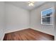 Bedroom features wood-look floors and bright window at 1902 Tumblewater Blvd, Ocoee, FL 34761