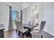 Formal dining room featuring a modern chandelier, wood floors, and a large window at 1902 Tumblewater Blvd, Ocoee, FL 34761