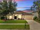 Charming single-Gathering home with lush front yard, a two-car garage, and inviting curb appeal at 1902 Tumblewater Blvd, Ocoee, FL 34761