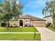 Charming single-Gathering home with lush front yard, a two-car garage, and inviting curb appeal at 1902 Tumblewater Blvd, Ocoee, FL 34761