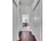 Hallway featuring wood flooring, closet and access to the bathroom with dual vanities at 1902 Tumblewater Blvd, Ocoee, FL 34761