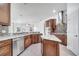 Gourmet kitchen featuring stainless steel appliances, granite countertops, and custom cabinets at 1902 Tumblewater Blvd, Ocoee, FL 34761