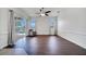 Open living space with dark wood floors and sliding glass doors to the pool at 1902 Tumblewater Blvd, Ocoee, FL 34761