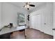 Home office with hardwood floors, ceiling fan, closet and natural light from the window at 1902 Tumblewater Blvd, Ocoee, FL 34761