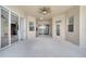 A covered outdoor patio featuring neutral coloring and multiple sliding glass doors to backyard and home at 1902 Tumblewater Blvd, Ocoee, FL 34761