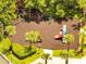 Aerial shot of the community playground featuring various play structures, slides, and mature trees at 1902 Tumblewater Blvd, Ocoee, FL 34761