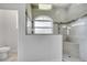 Walk in shower featuring decorative shower head, stone walls and a small window at 1902 Tumblewater Blvd, Ocoee, FL 34761