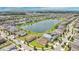 Aerial view of a neighborhood surrounding a large pond at 2009 Napoli Dr, St Cloud, FL 34771