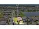 Aerial view of the property and the surrounding community, including a pond at 2009 Napoli Dr, St Cloud, FL 34771