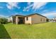 Spacious backyard with lush green lawn and a screened-in patio, perfect for outdoor living at 2009 Napoli Dr, St Cloud, FL 34771