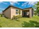 Spacious backyard featuring a screened patio, lush green grass, and meticulous landscaping at 2009 Napoli Dr, St Cloud, FL 34771