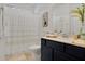 Well-lit bathroom with a modern vanity, shower curtain, and decor at 2009 Napoli Dr, St Cloud, FL 34771