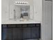Modern bathroom featuring a double vanity, large mirror, and storage cabinets at 2009 Napoli Dr, St Cloud, FL 34771