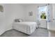 Cozy bedroom with a twin bed, soft carpet, and window with decorative curtains at 2009 Napoli Dr, St Cloud, FL 34771