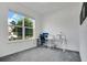 Bright bedroom with a large window offering pleasant outdoor views, desk, and carpeted floor at 2009 Napoli Dr, St Cloud, FL 34771