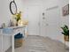 Welcoming entryway featuring a white table, decorative mirror, and tiled flooring at 2009 Napoli Dr, St Cloud, FL 34771