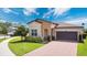 Beautiful one-story home with a two-car garage, manicured landscaping, and a brick driveway at 2009 Napoli Dr, St Cloud, FL 34771