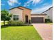 Charming one-story home with a two-car garage, beautiful landscaping, and a brick driveway at 2009 Napoli Dr, St Cloud, FL 34771