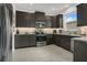 Modern kitchen featuring dark cabinetry, granite countertops, and stainless steel appliances at 2009 Napoli Dr, St Cloud, FL 34771
