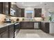 Modern kitchen featuring granite countertops, stainless steel appliances and dark cabinetry at 2009 Napoli Dr, St Cloud, FL 34771