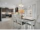 Open concept kitchen and dining area featuring dark cabinets and modern finishes at 2009 Napoli Dr, St Cloud, FL 34771