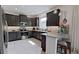 Modern kitchen with stainless steel appliances, dark cabinets and breakfast bar with stools at 2009 Napoli Dr, St Cloud, FL 34771