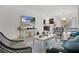 Open-concept living room with a kitchen view, a modern leather sofa, and patterned chairs at 2009 Napoli Dr, St Cloud, FL 34771