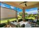 Relaxing screened patio featuring comfortable seating and views of the well-maintained backyard at 2009 Napoli Dr, St Cloud, FL 34771