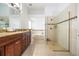 Spacious bathroom with a glass-enclosed shower, granite countertops, and a separate soaking tub at 2547 Raccoon Run Ln, Orlando, FL 32837