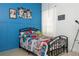 Vibrant bedroom features a comic-themed bed, colorful artwork, and a 'Game Room' sign for a playful atmosphere at 2547 Raccoon Run Ln, Orlando, FL 32837